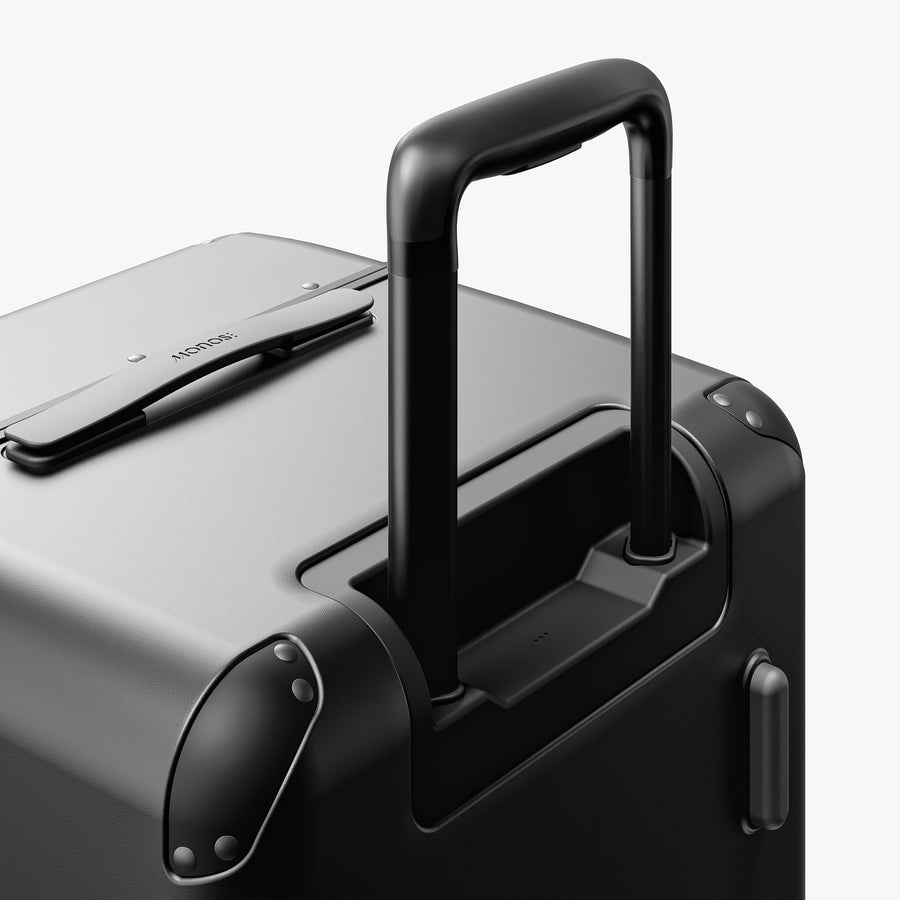 Obsidian | Extended luggage handle view of Hybrid Trunk in Obsidian