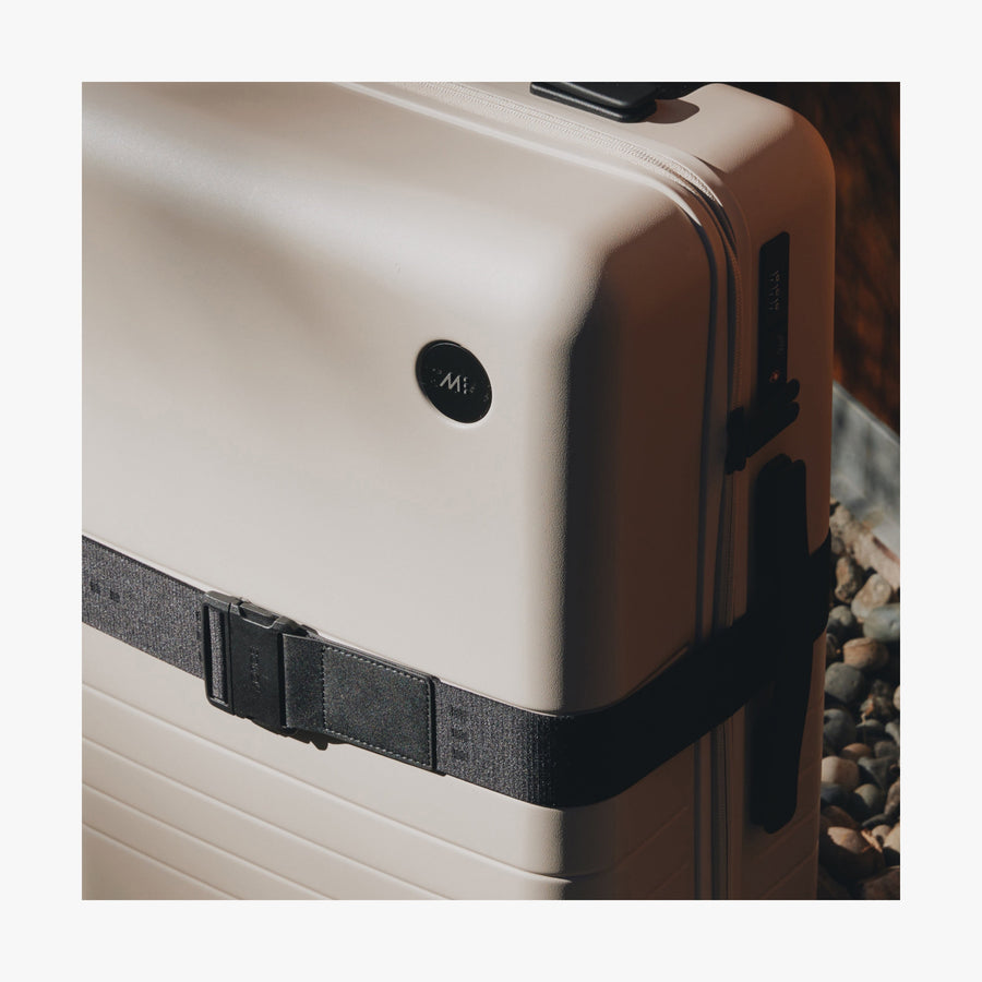 Ocean Blue | Close-up view of a suitcase with the Midnight Black Luggage Strap secured around it showing the fabric details and buckle