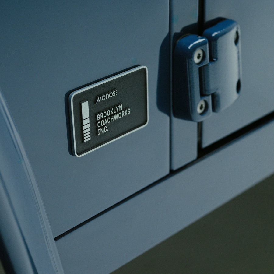 Arles Blue | Close-up of Monos x Brooklyn Coachworks metal plate on Land Rover Defender