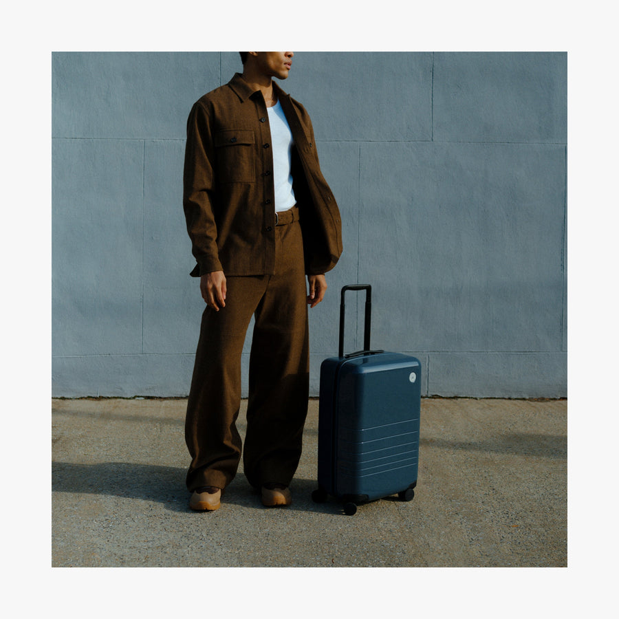 Set of Six / Arles Blue | Man standing next to a Carry-On in Arles Blue