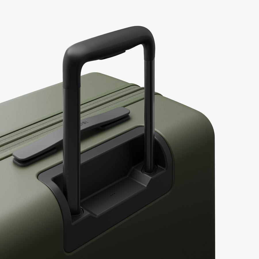 Olive Green | Extended luggage handle view of Expandable Check-In Medium in Olive Green
