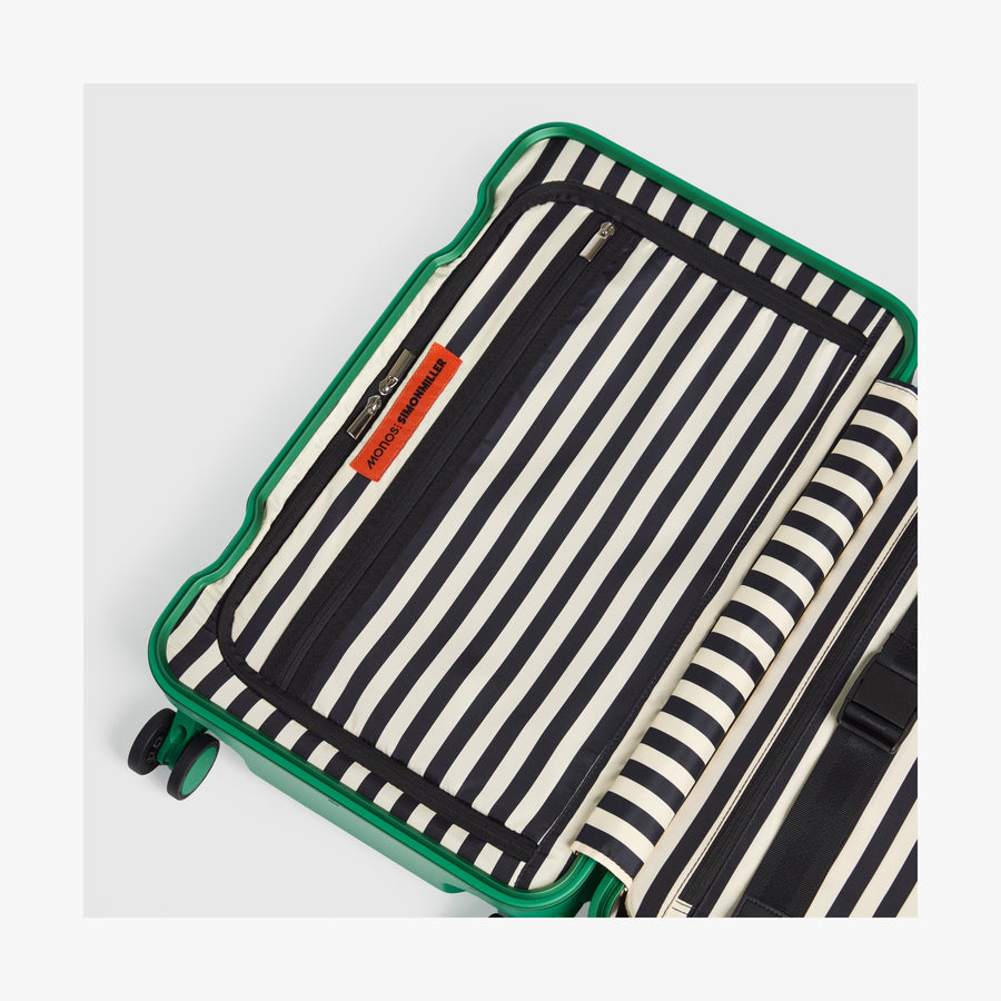 Jungle Green | Interior view of a Hybrid suitcase in Jungle Green featuring the Poplin Stripe Jungle Green zipped compartment