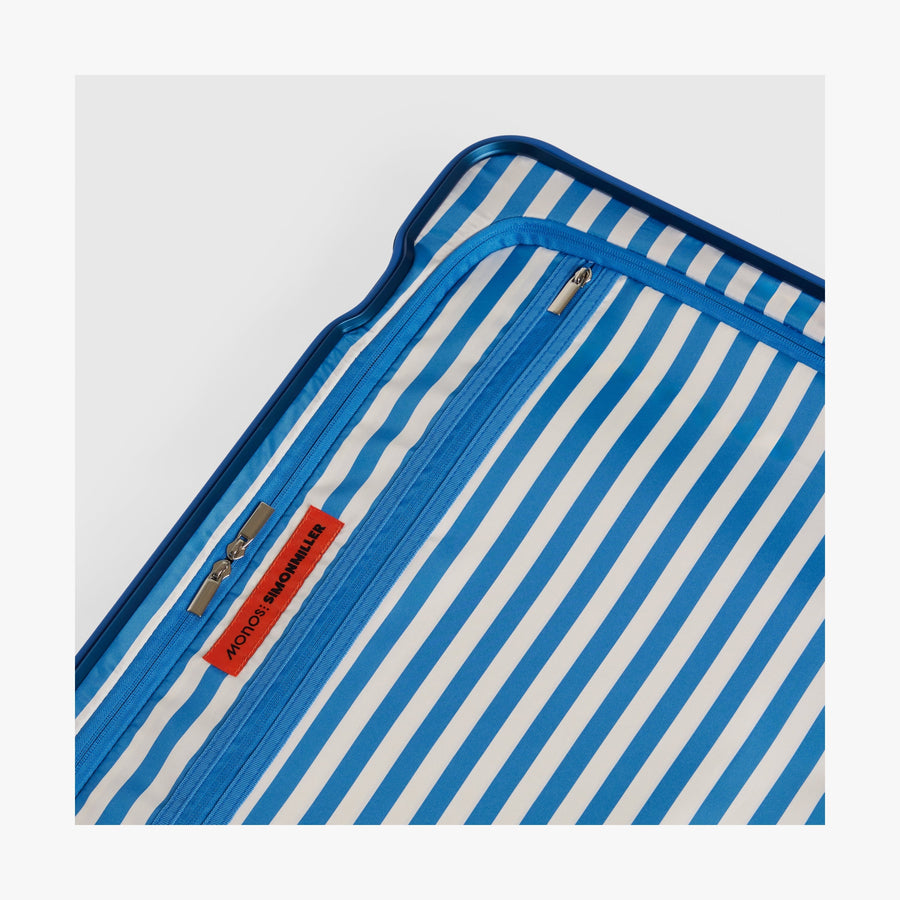 Coastal Blue | Close-up view of the Hybrid suitcase interior in Coastal Blue, featuring the Poplin Stripe Coastal Blue zipped compartment