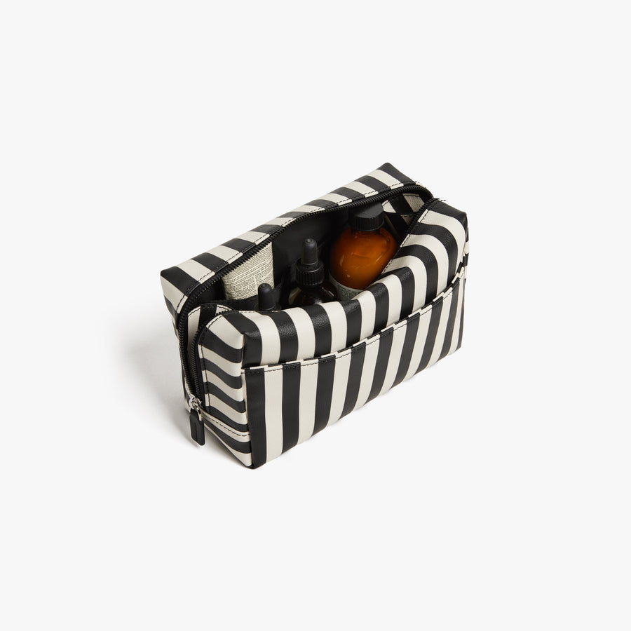 Large/ Poplin Stripe Black | Back angled view of the opened large Metro Toiletry Case in Poplin Stripe Black, showing travel essentials stored inside