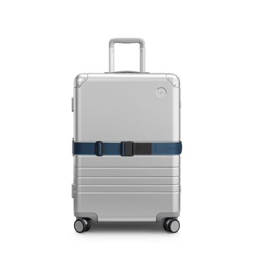 Front view of Aluminum suitcase with the Ocean Blue Luggage Strap secured around it